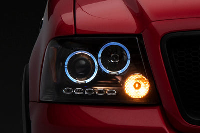 Raxiom 04-08 Ford F-150 Dual LED Halo Projector Headlights- Black Housing (Clear Lens) - Lights