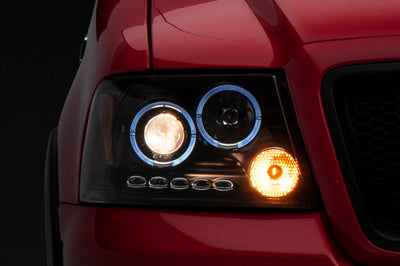 Raxiom 04-08 Ford F-150 Dual LED Halo Projector Headlights- Black Housing (Clear Lens) - Lights