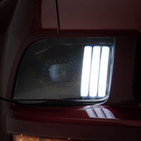 Raxiom 05-09 Ford Mustang w/ Halogen Prjctor Headlights- Black Housing (Clear Lens) (No GT500) Lights