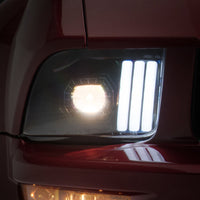 Raxiom 05-09 Ford Mustang w/ Halogen Prjctor Headlights- Black Housing (Clear Lens) (No GT500) Lights