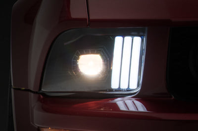 Raxiom 05-09 Ford Mustang w/ Halogen Prjctor Headlights- Black Housing (Clear Lens) (No GT500) Lights