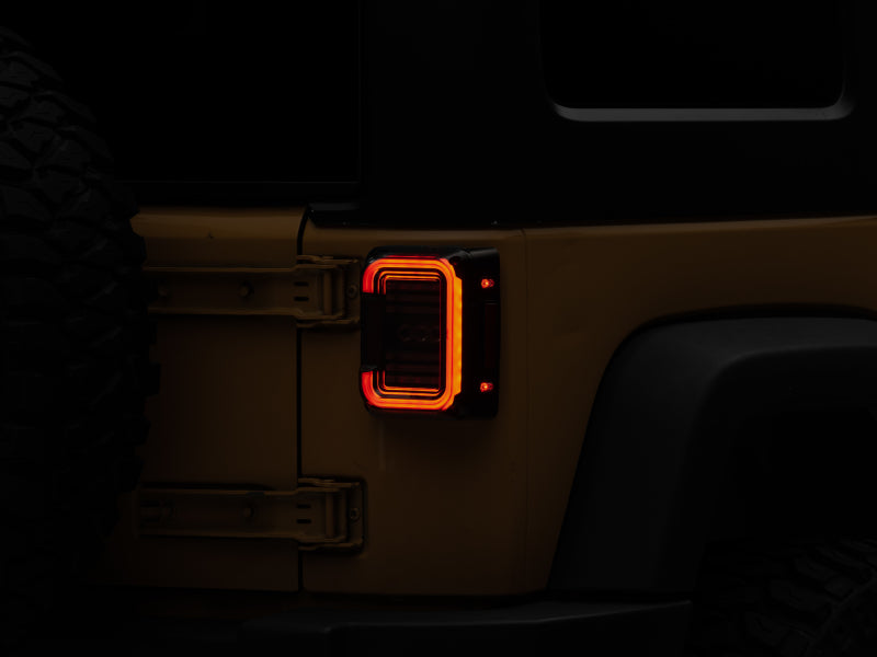 Raxiom 07-18 Jeep Wrangler JK Axial Series LED Halo Tail Lights- Black Housing (Dark Smoked Lens) - Lights