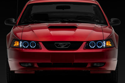 Raxiom 99-04 Ford Mustang Dual LED Halo Projector Headlights- Black Housing (Clear Lens) - Lights