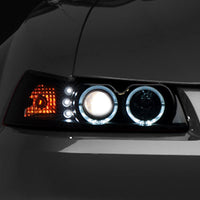 Raxiom 99-04 Ford Mustang Dual LED Halo Projector Headlights- Black Housing (Smoked Lens) - Lights
