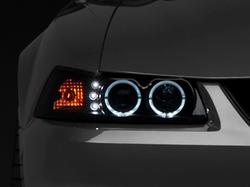 Raxiom 99-04 Ford Mustang Dual LED Halo Projector Headlights- Black Housing (Smoked Lens) - Lights