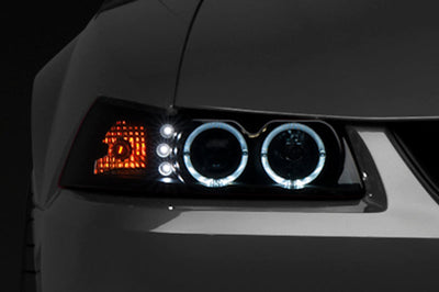 Raxiom 99-04 Ford Mustang Dual LED Halo Projector Headlights- Black Housing (Smoked Lens) - Lights