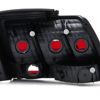 Raxiom 99-04 Ford Mustang Excluding 99-01 Cobra Tail Lights- Black Housing (Smoked Lens) - Lights
